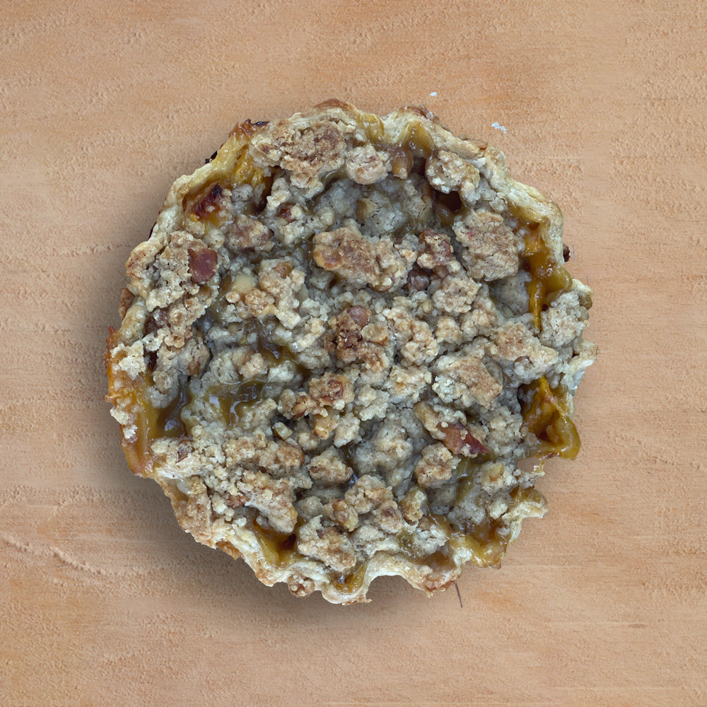 Peach pie on a wooden surface